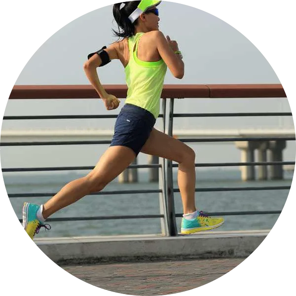 Young woman running by the water