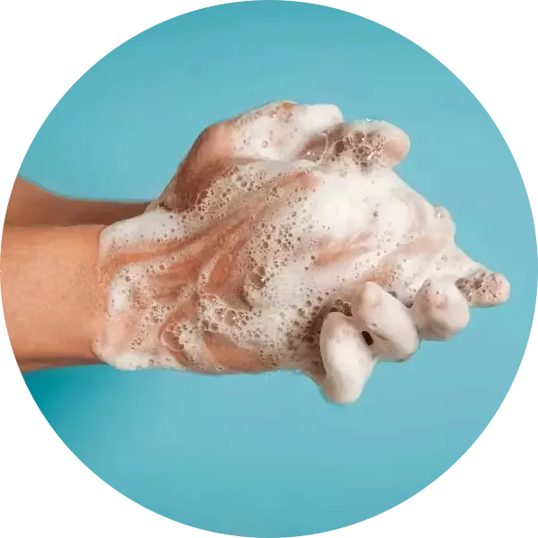 Close-up of person washing hands against blue background