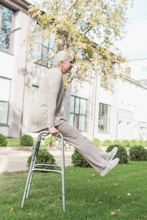 side-view-of-happy-senior-woman-exercising-with-wa-2023-11-27-05-12-28-utc.jpg