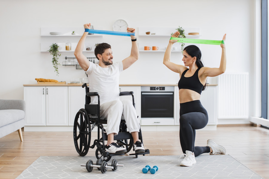 wife-helping-mature-man-in-wheelchair-lifting-arms-2024-02-14-20-58-24-utc.jpg