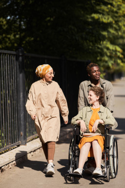 pushing-disabled-woman-in-wheelchair-during-stroll-2023-11-27-05-10-51-utc.jpg