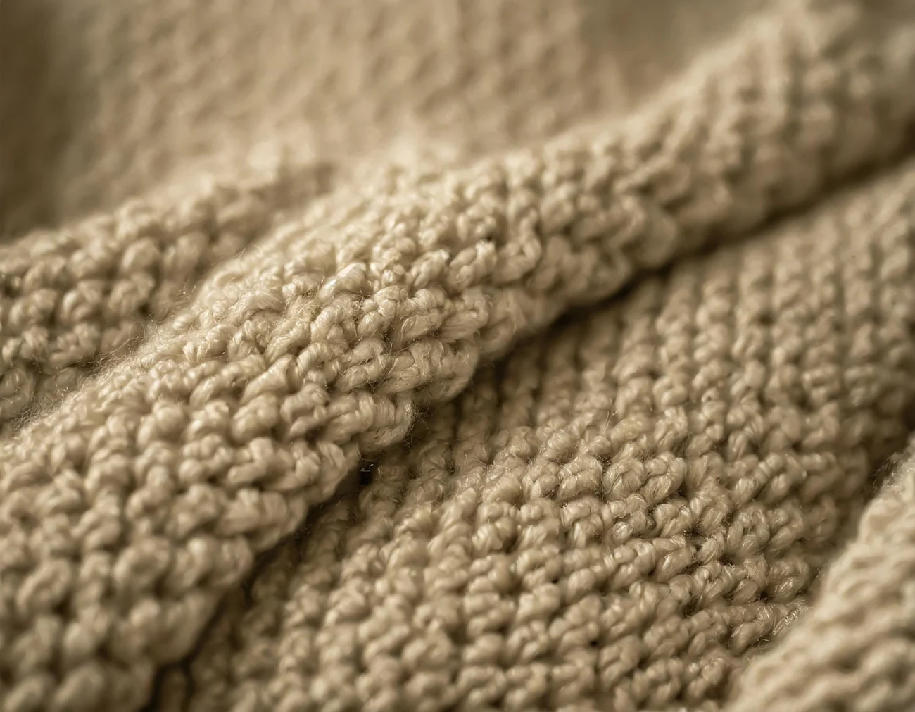 Firefly fabric, knitted jacket, close-up, dusty golden beige shades; fashionable textile material; t