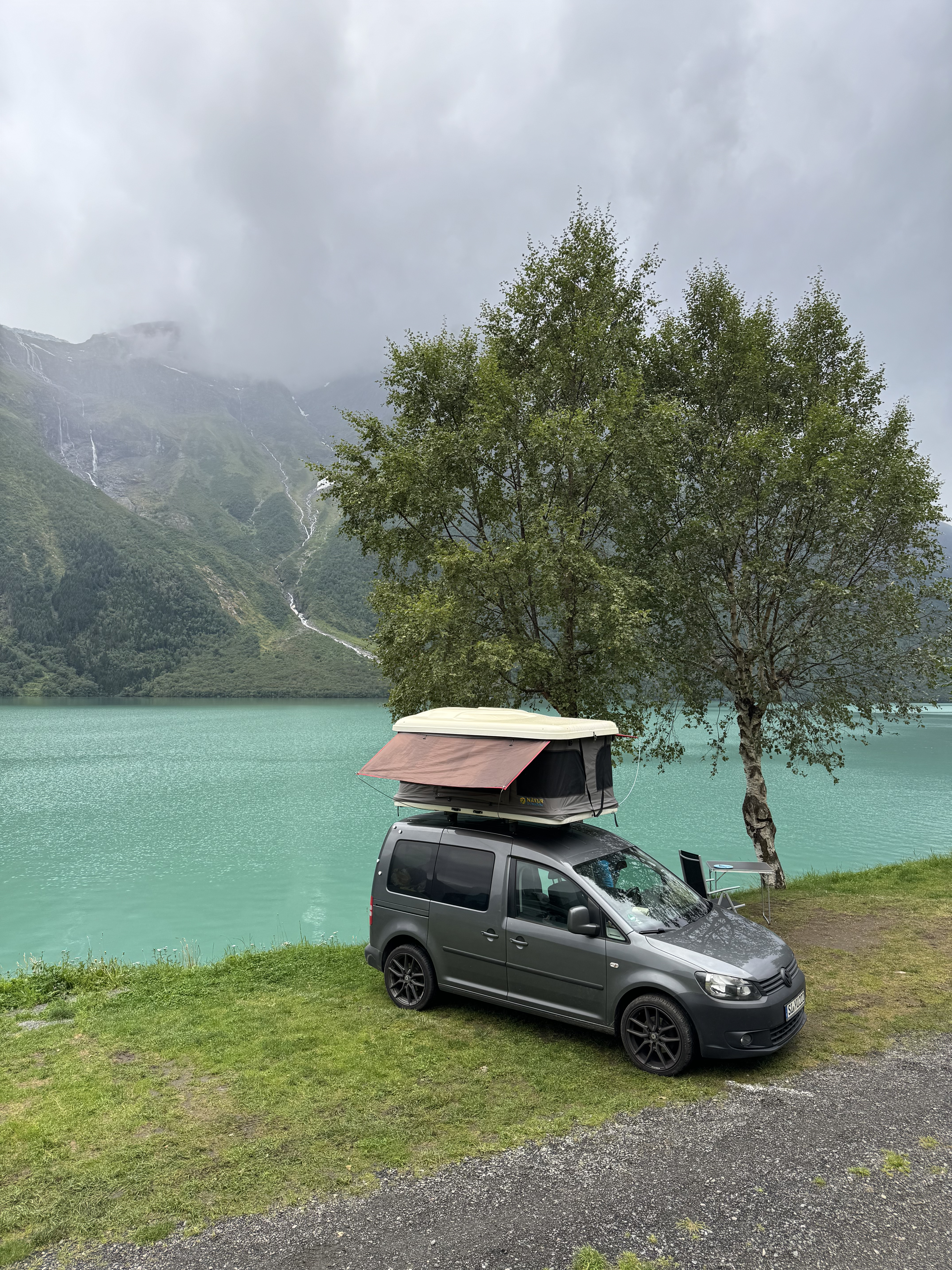 Camper mit Dachzelt an einem Fjord in Norwegen