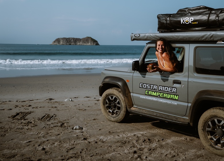 Frau parkt mit einem Camper am Strand von Costa Rica 
