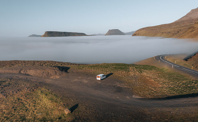 Camper in Island zwischen Bergen und Meer