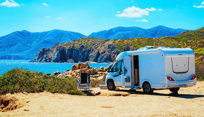 A camper parks on a stretch of coastline on the Italian island of Sardinia