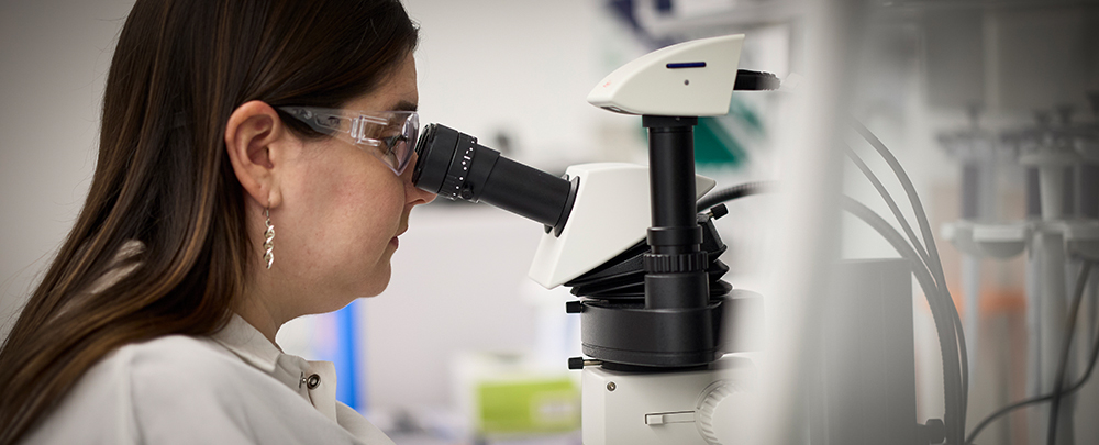woman looking in microscope