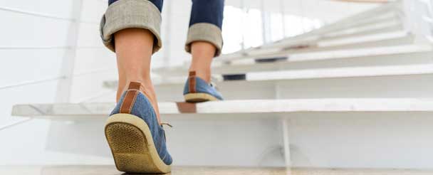 close up of feet walking up stairs