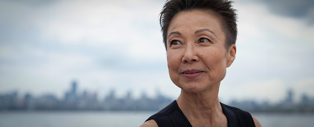 An Asian woman looks off into the distance