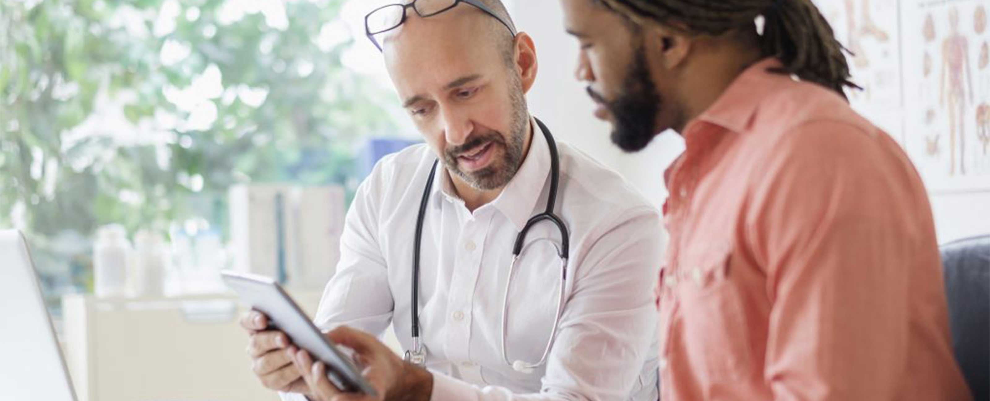 doctor showing a patient something on a tablet device