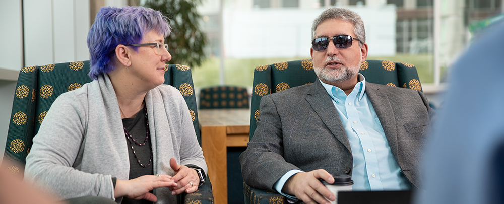 woman and man wearing sunglasses talking