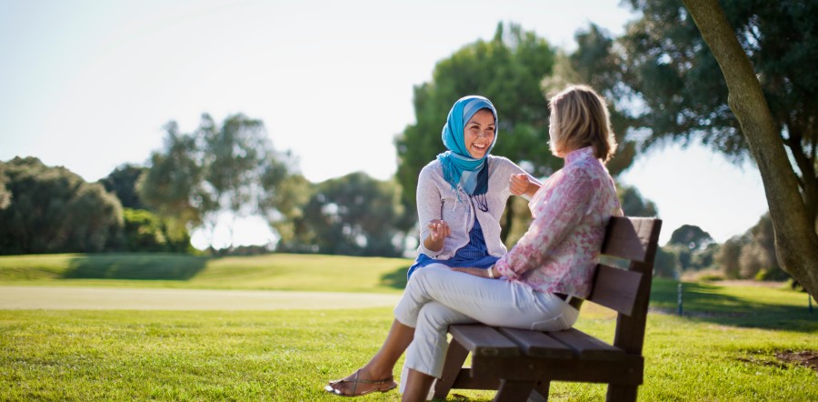 two people talking on park bench