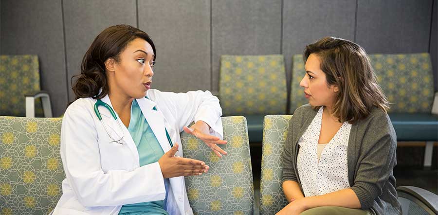 doctor talking to patient on bench