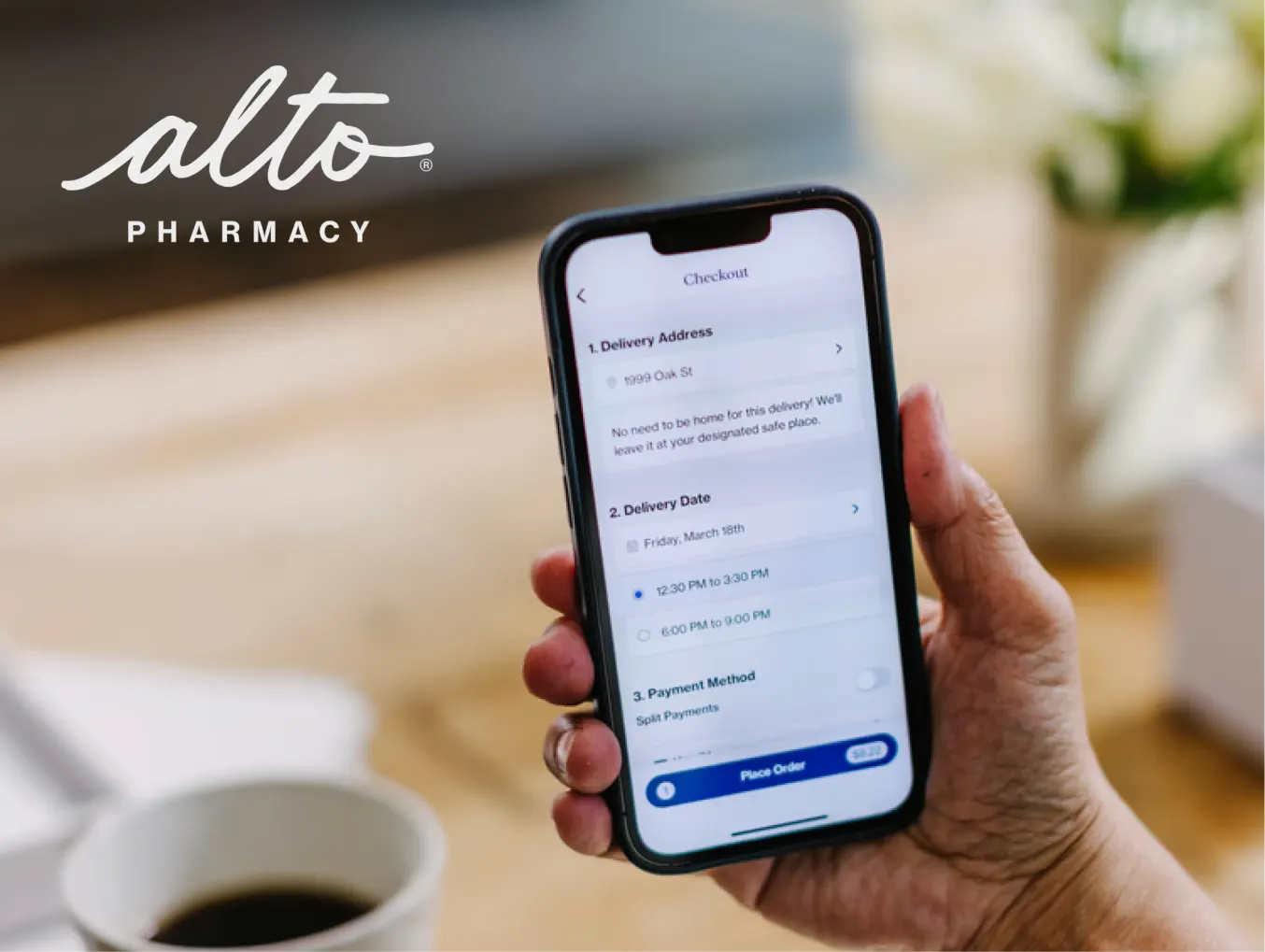 "Alto Pharmacy advertisement featuring a hand holding a smartphone displaying a checkout screen. The screen shows options to select a delivery address, delivery date, and payment method. The Alto Pharmacy logo is visible at the top left of the image. The background includes a blurred view of a table with a cup and some flowers."