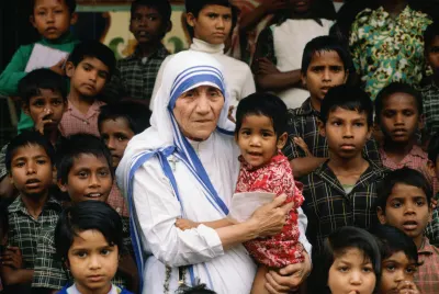 Mother Teresa accompanied by children at her mission in Calcutta (Tim Graham, Getty Images)
