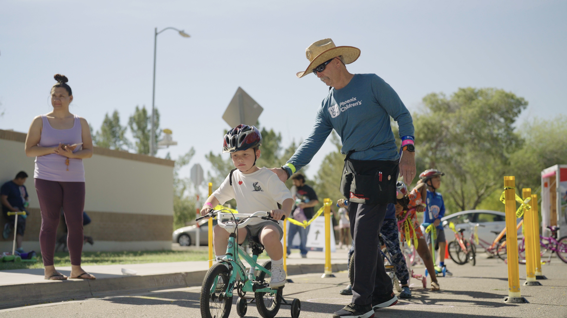Child guided through safety cones at the Phoenix Children's Bike Rodeo