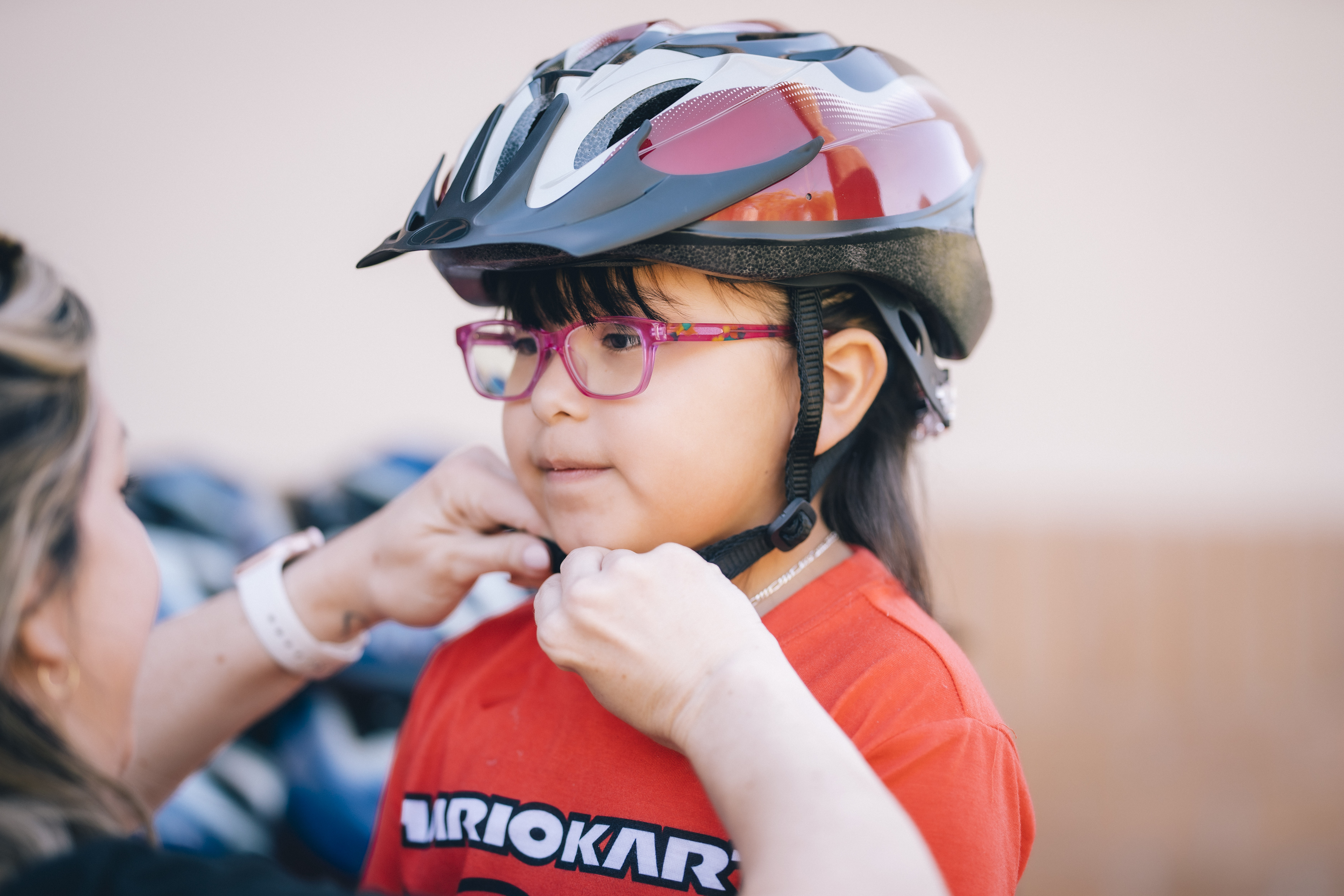 Child being fitted for a new helmet at the Phoenix Children's Bike Rodeo