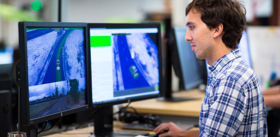 Man at computer analyzing a Waymo cars POV while driving