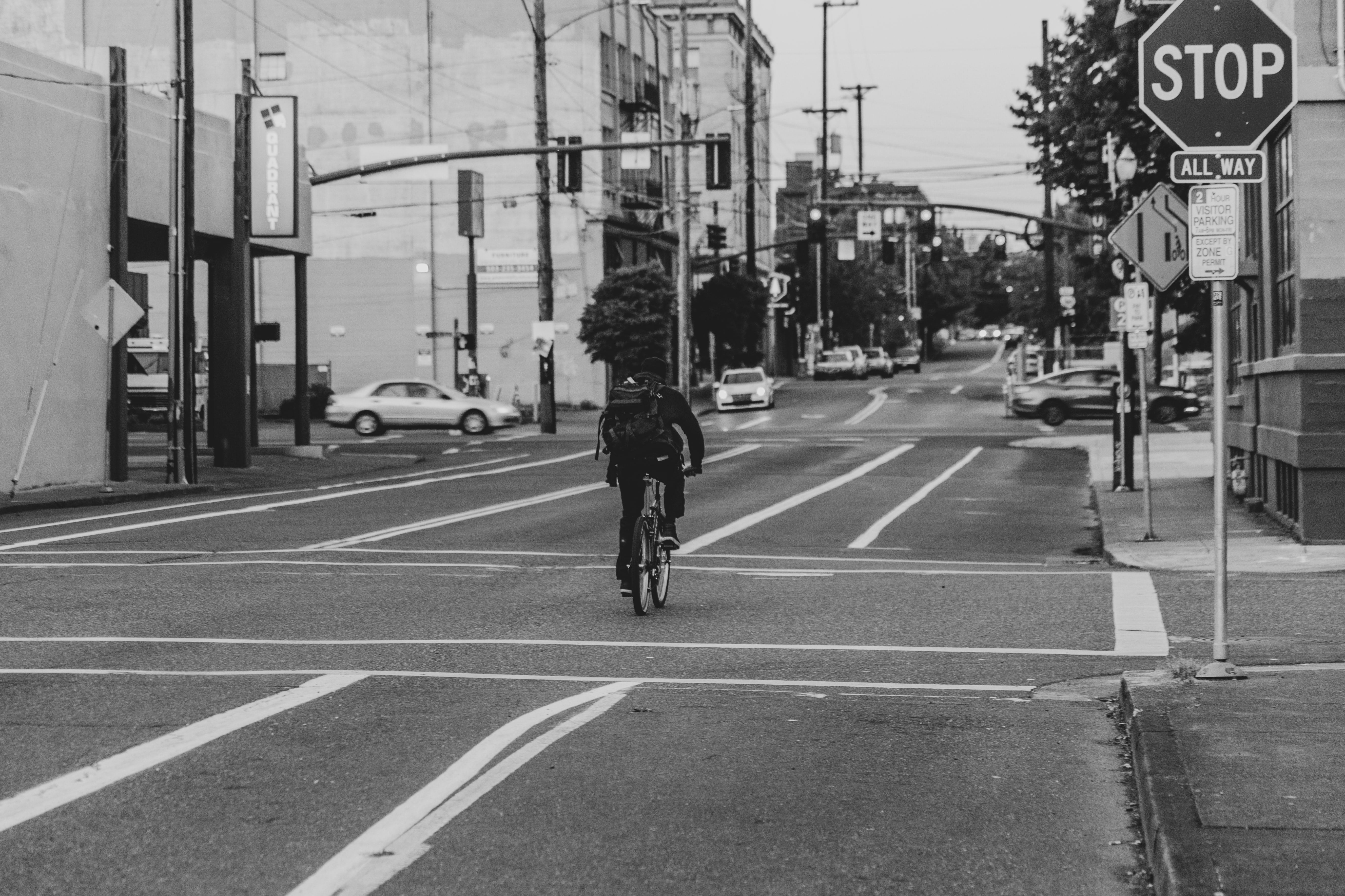 Black and white image of someone biking