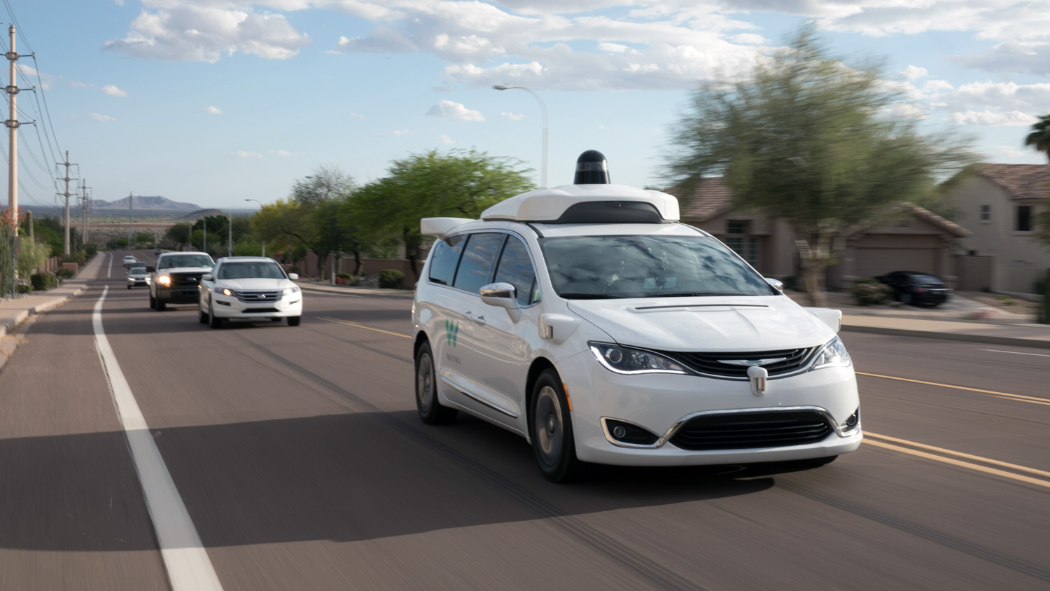 Autonomous vehicle driving down a road