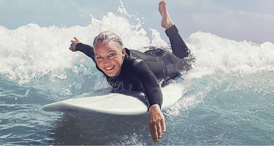 woman surfer swim on surfing board
