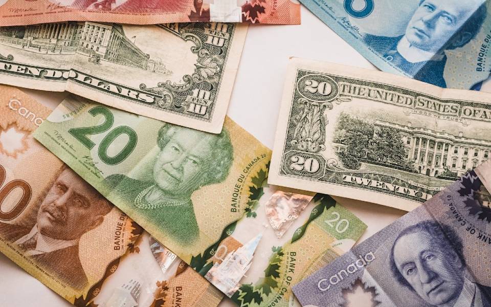 Should you pay in USD or local currency?