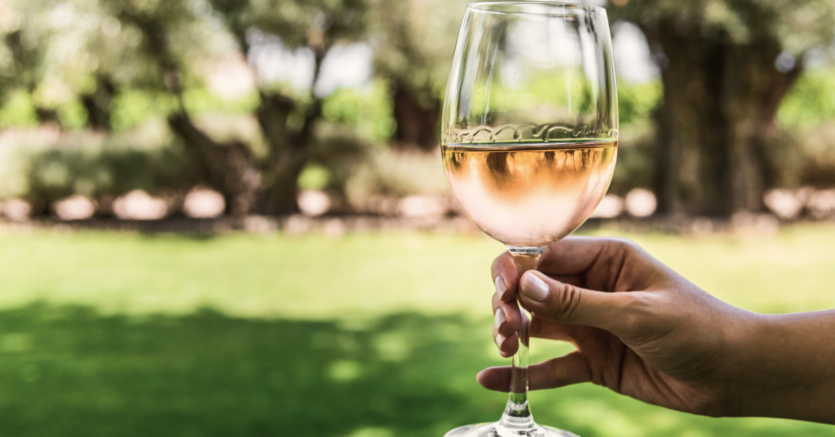 A woman's hand holding a glass of rose