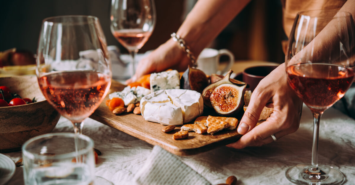 Image of cheeseboard and glasses of rose