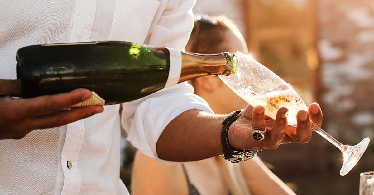 An image of a man pouring champagne