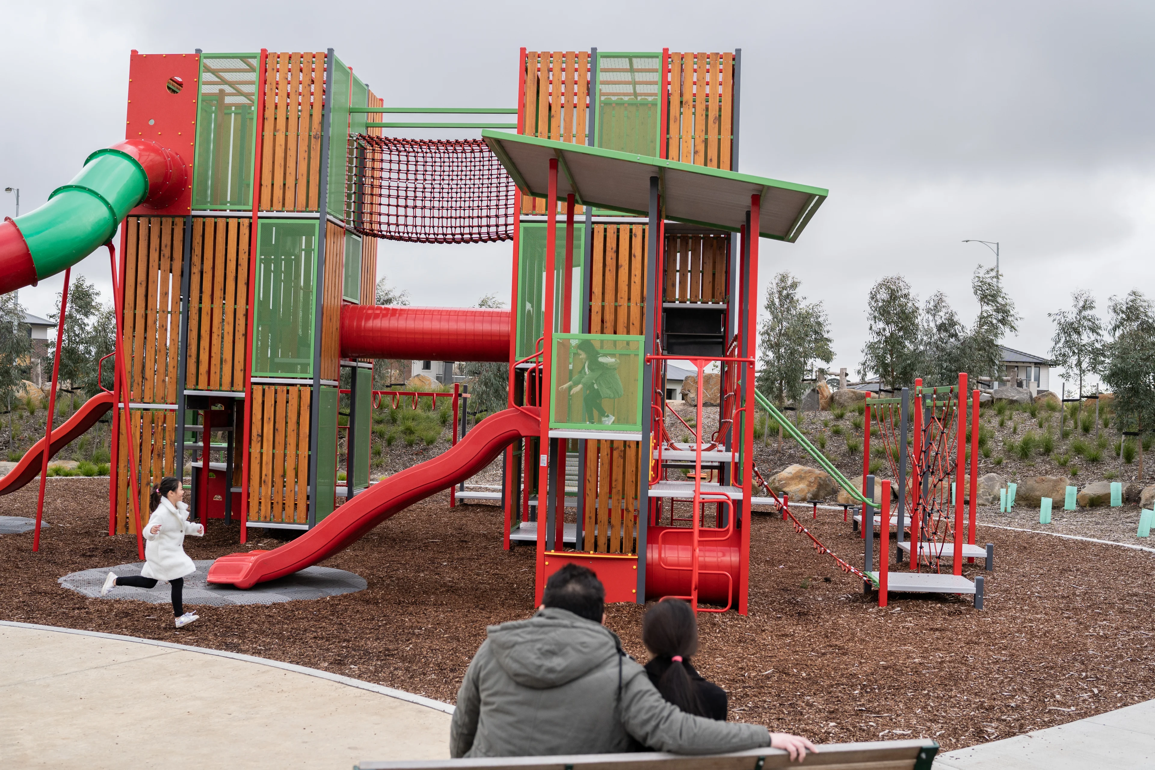 Girl running near slide at large playground structure at Lucas Central Park Playground, Ballarat