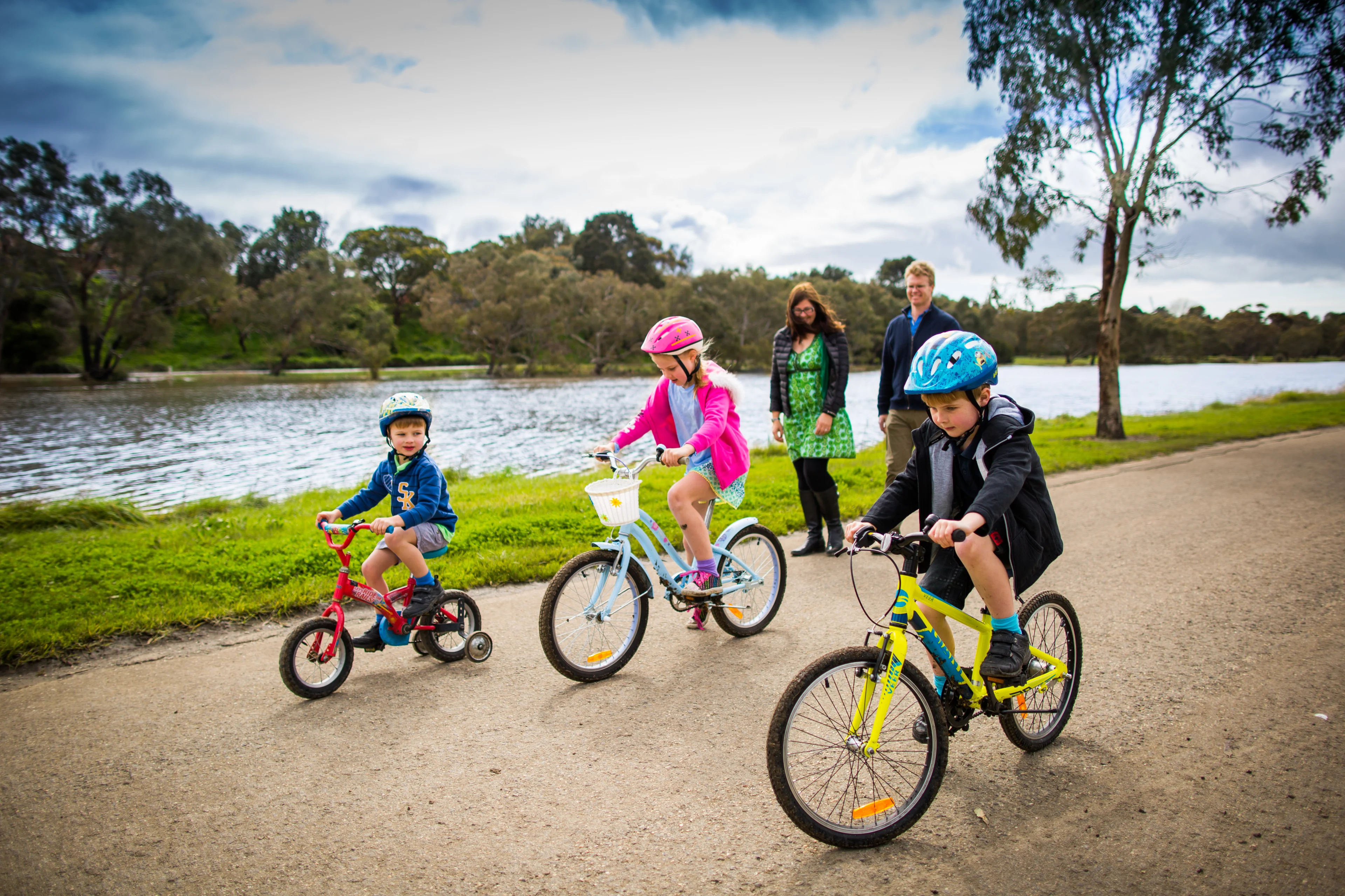 Family walking and cycling along the Barwon River at Geelong, Victoria