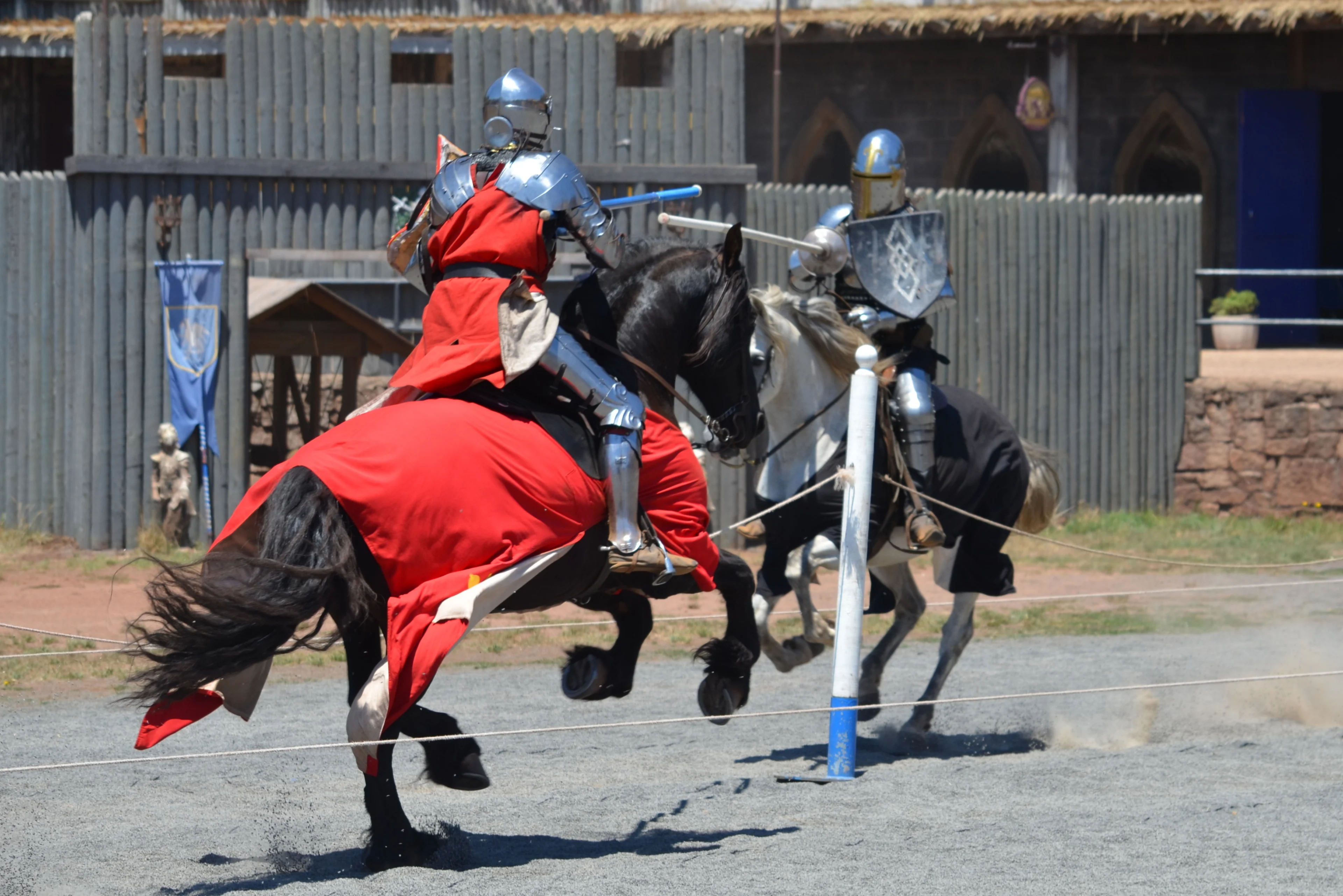 Two knights in armour jousting on black horses at Kyral Castle, Ballarat