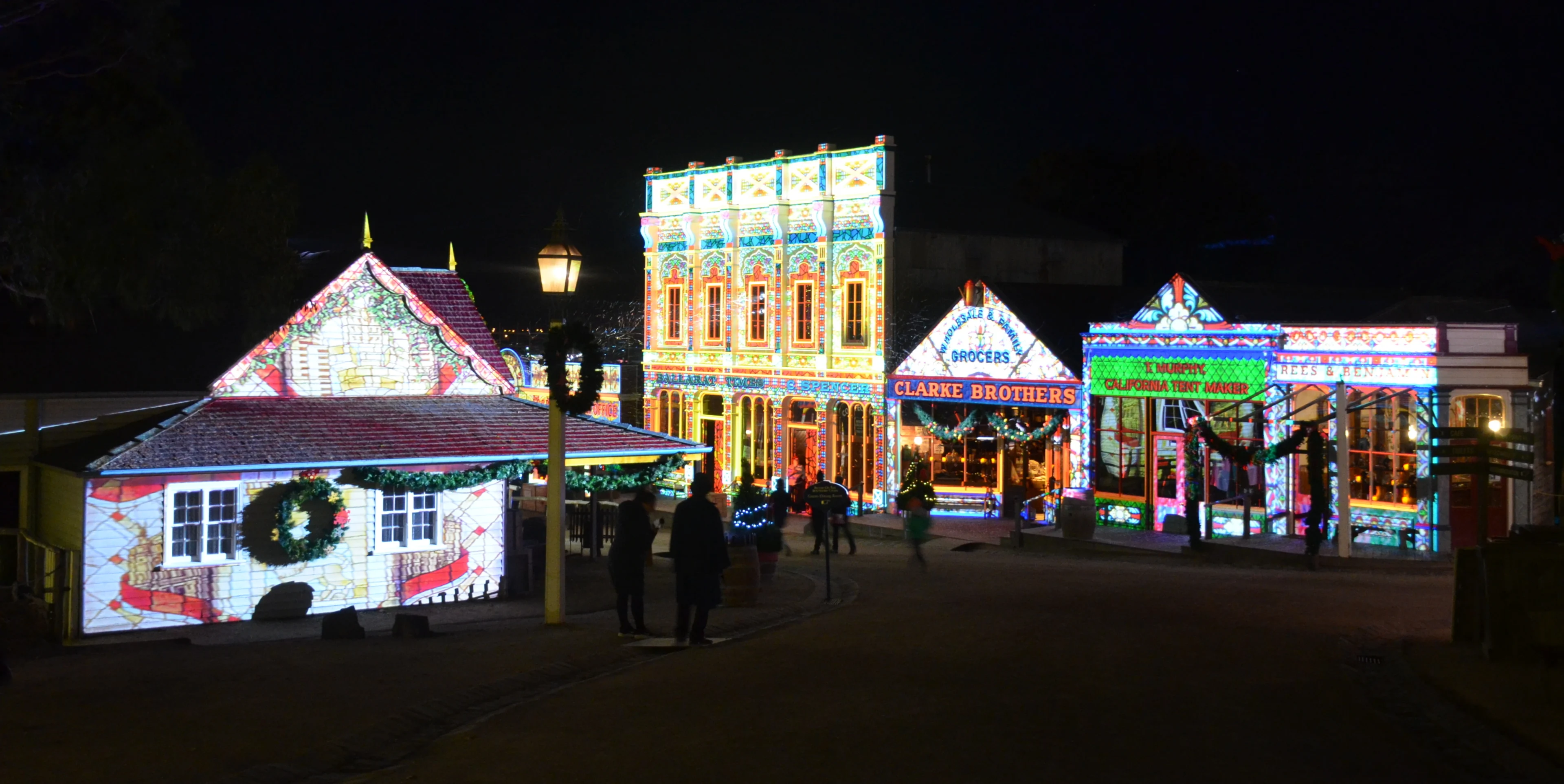 Buildings lit up in bright lights at Winter Wonderlights at Sovereign Hill