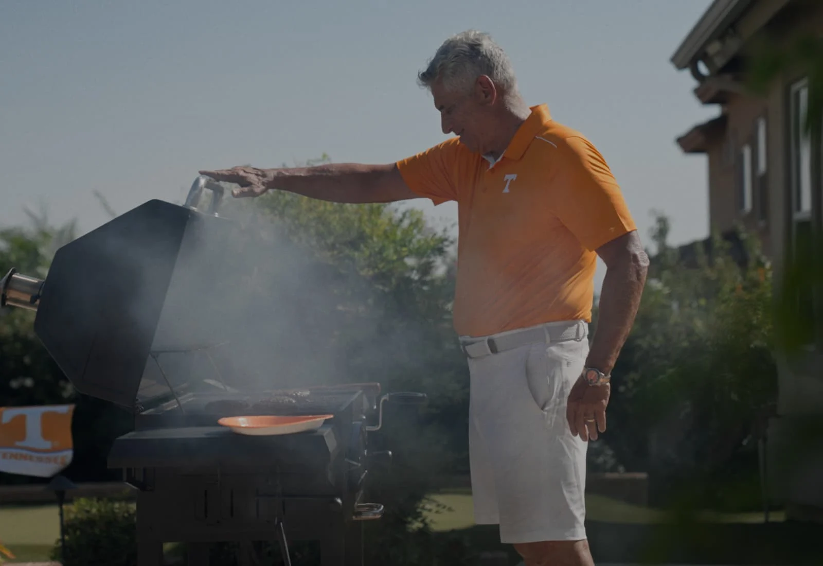 Paul Johnson standing in front of a smoking grill