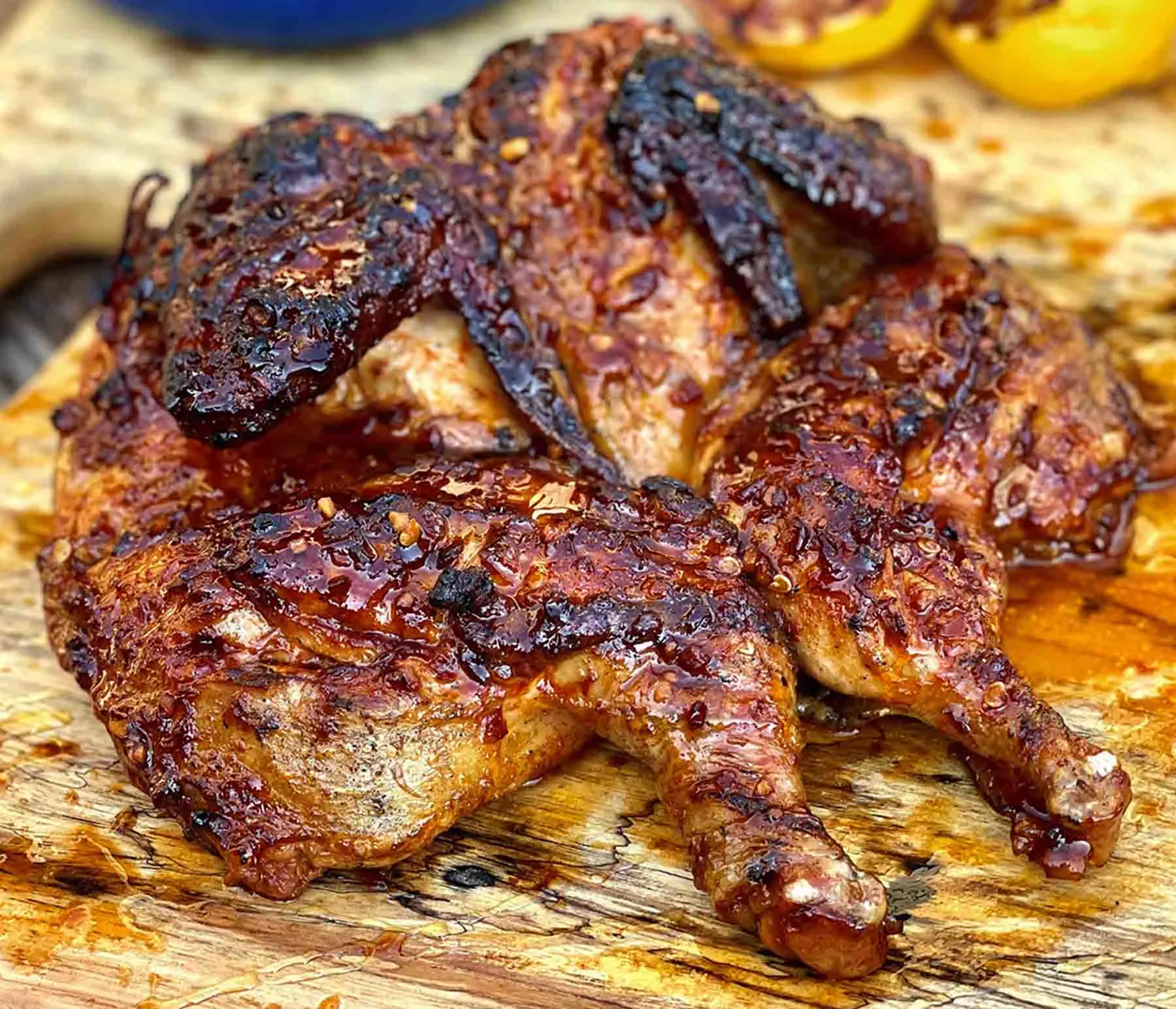 Spatchcocked chicken on a wood cutting board