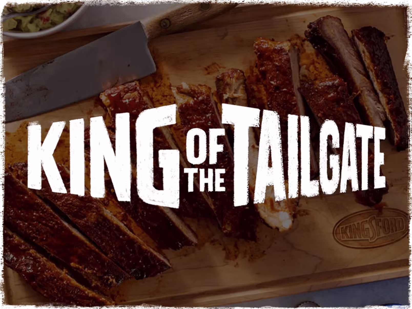 Blurred image of ribs on a cutting board with the stylized words "King of the Tailgate" over it