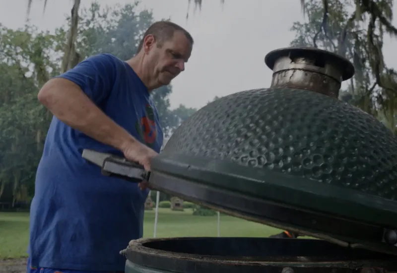 Chad Carr barbecuing in an egg-shaped grill