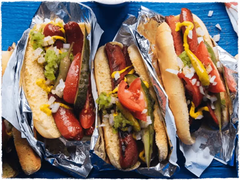 A tailgate setup with a grill and food