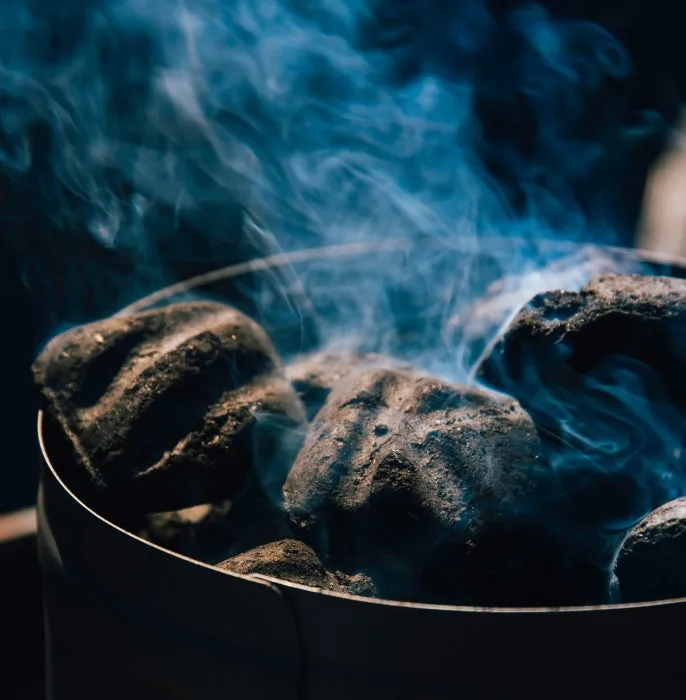 Charcoal smoking in a charcoal starter chimney