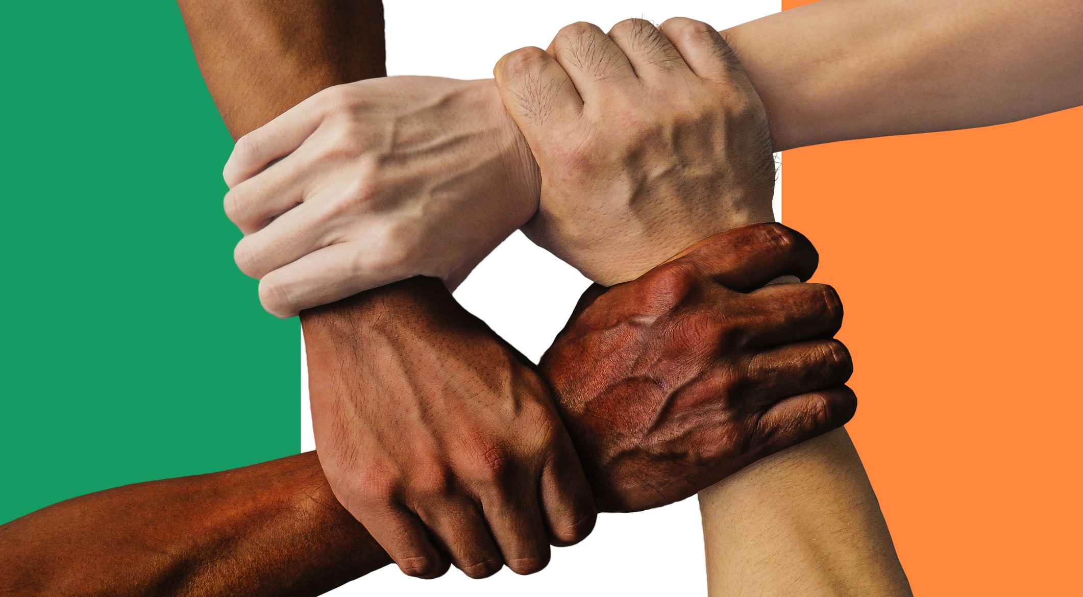 Four hands symbolise strength in unity by clenching each other's accompanying arms to form a square over the flag of Ireland