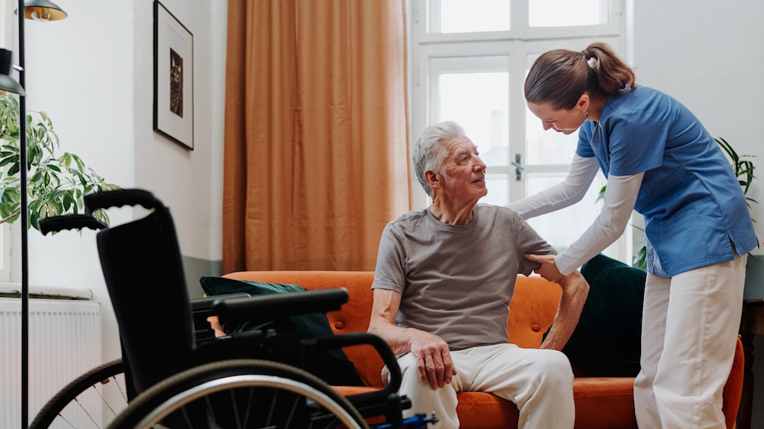 Occupational therapist assessing home for man using wheelchair