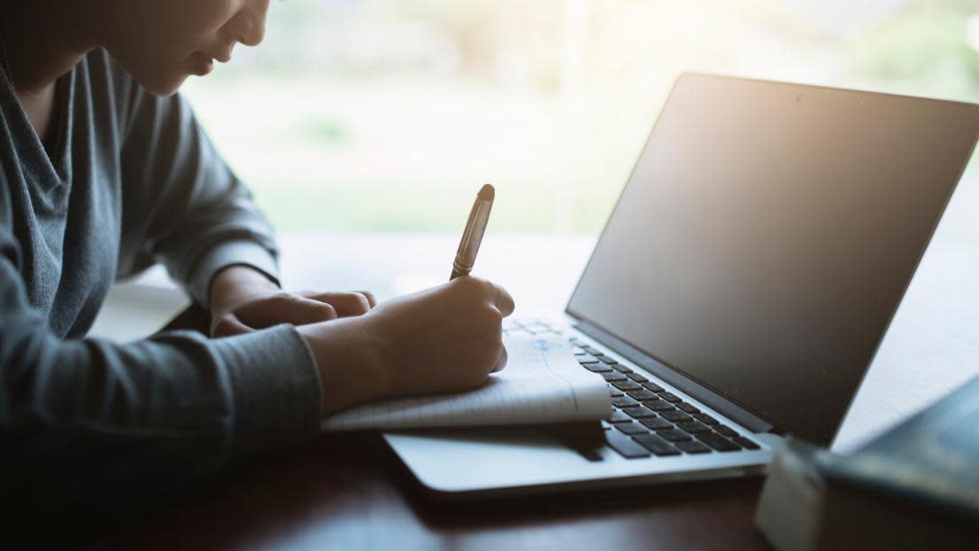 Student with laptop researching higher education
