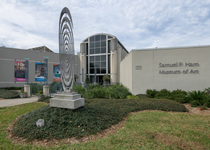Exterior of the Samuel P. Harn Museum of Art at the University of Florida in Gainesville, with a large, silver spiral sculpture on a small lawn