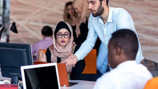Young business people working on a project in an office.
