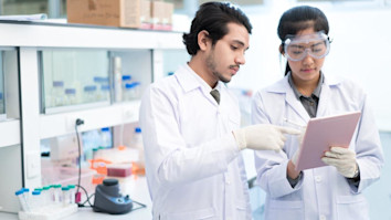Two scientists working in a library