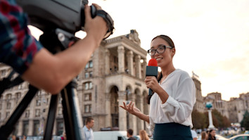 TV reporter presenting the news outdoors. Journalism industry, live streaming.