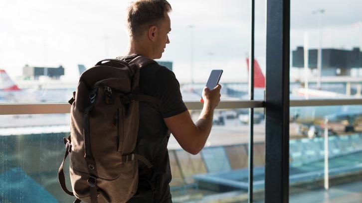 Man with backpack walking in airport