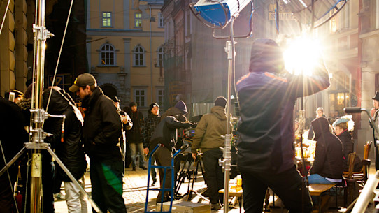 Work of a film crew on a city street at nighttime with bright lights