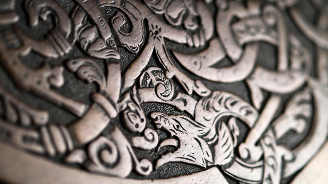 Viking wood carving depicting a wolf or a dragon, low depth of field