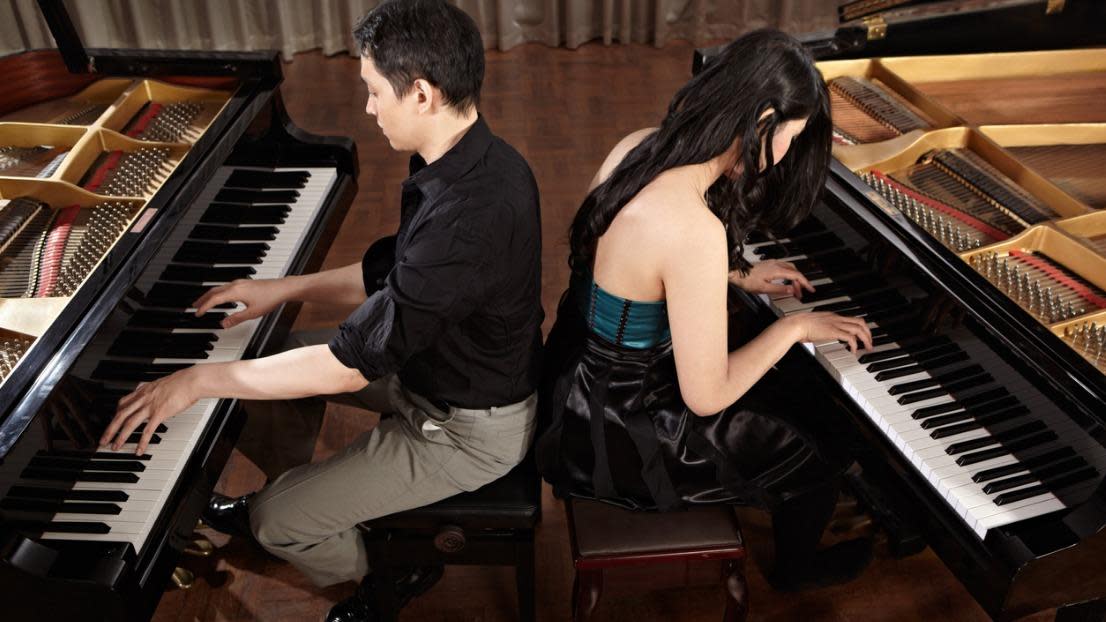 Two pianists playing a duet